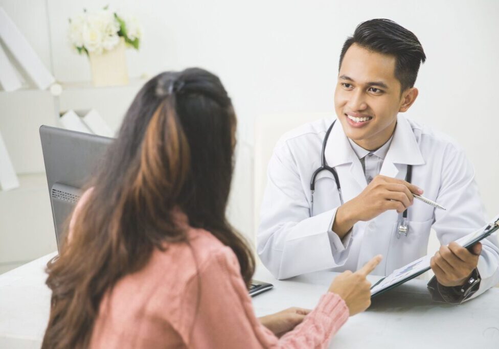 Doctor consulting with a patient in office.
